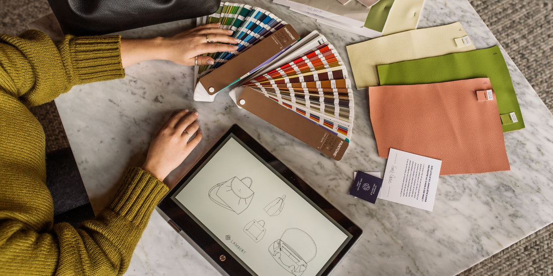Overhead view of the Lambert design process, featuring bag sketches on a tablet, color swatches, and textured material samples.